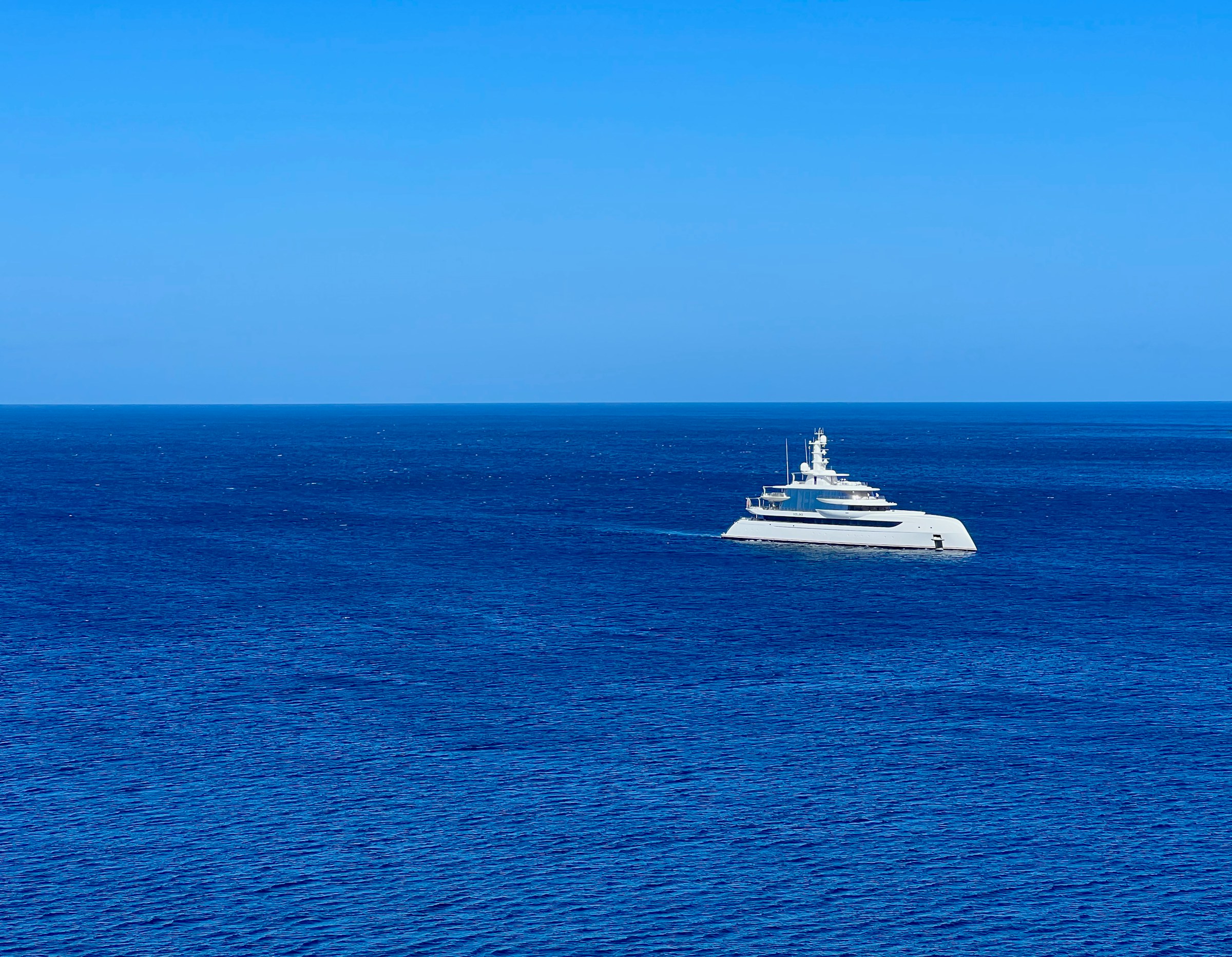 Superyacht at sea in deep blue water